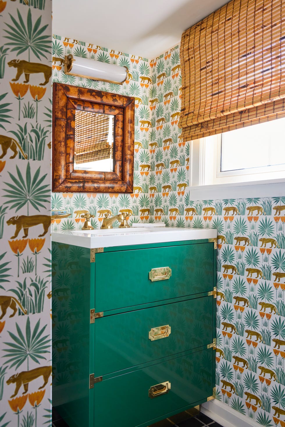 Stylish bathroom with green vanity and patterned wallpaper