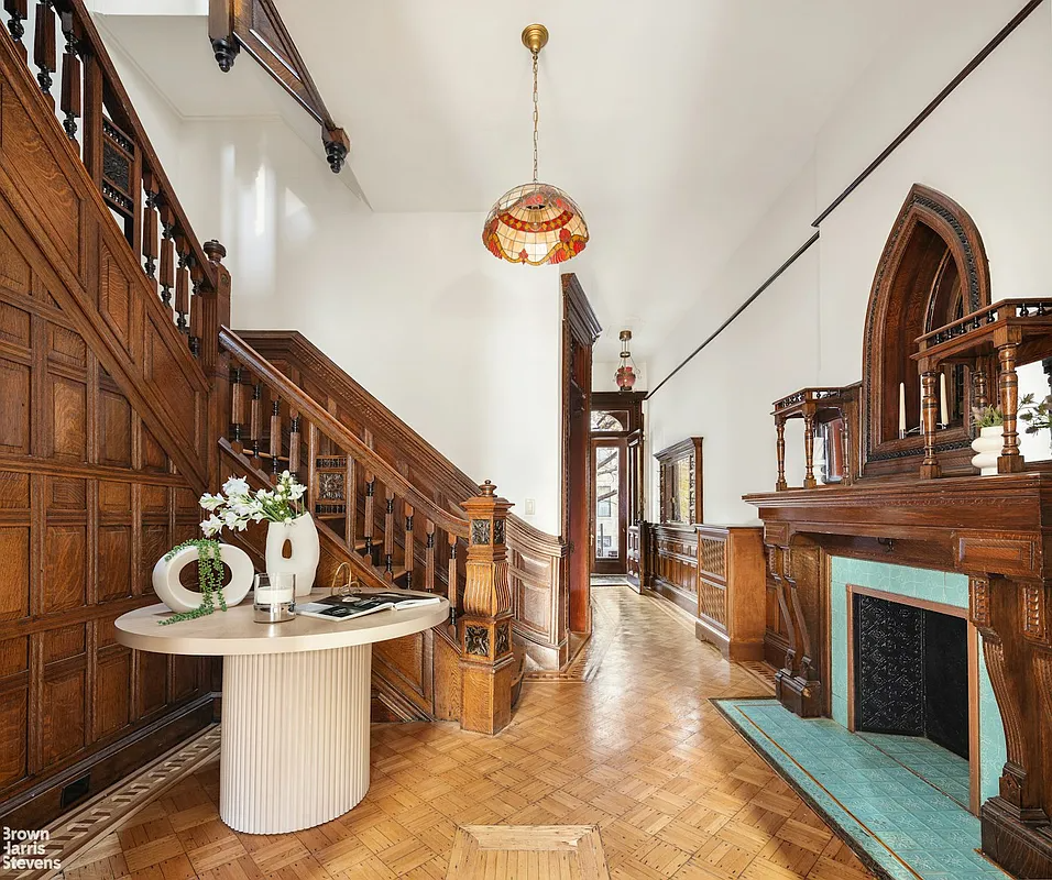 Bedroom - mid-sized living room with staircase, ornate mantel and hardwood floors