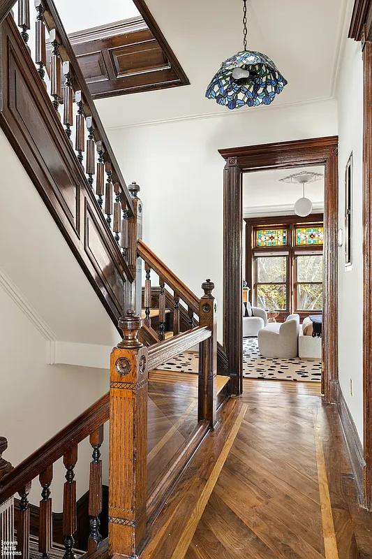 Hallway with unpainted woodwork on the original staircase