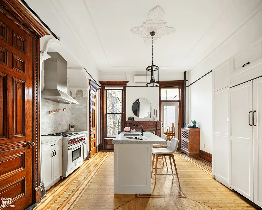 Kitchen with center island, ceiling medallion and white cabinets