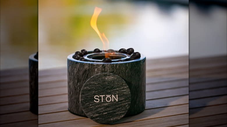 A smokeless fire pit from StonHome sits on a patio table