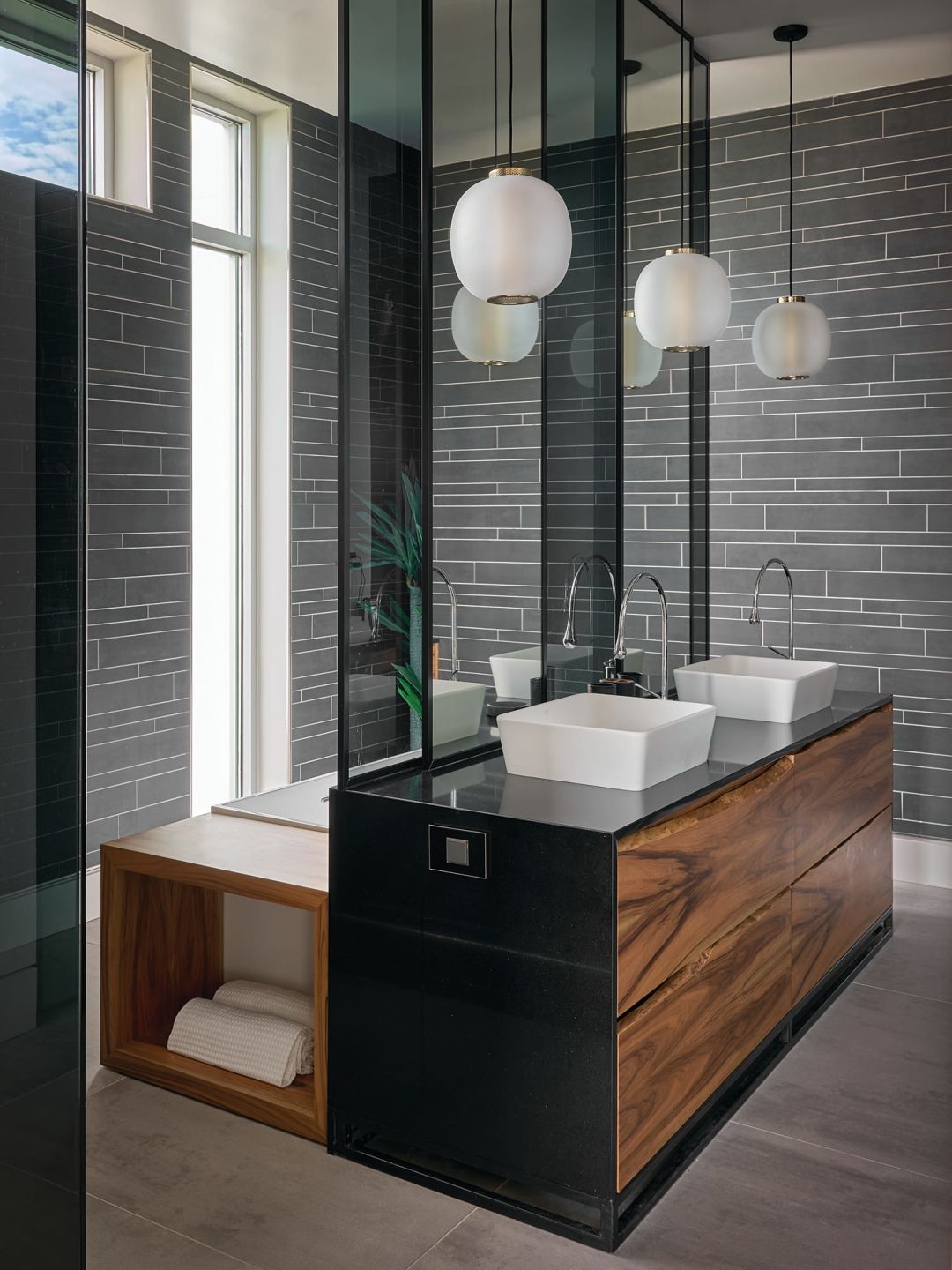 Wood grain adds an organic touch to an atmospheric bathroom.