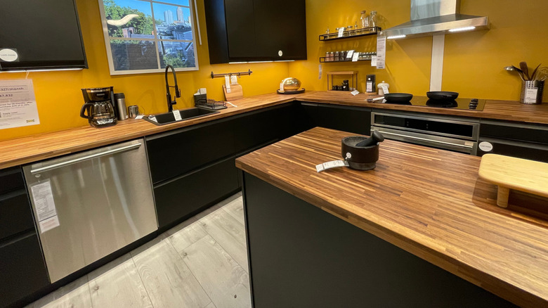 An IKEA kitchen showroom features black cabinets.