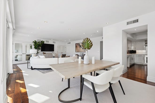 The living and dining areas flow into each other. The door on the right leads to the kitchen.