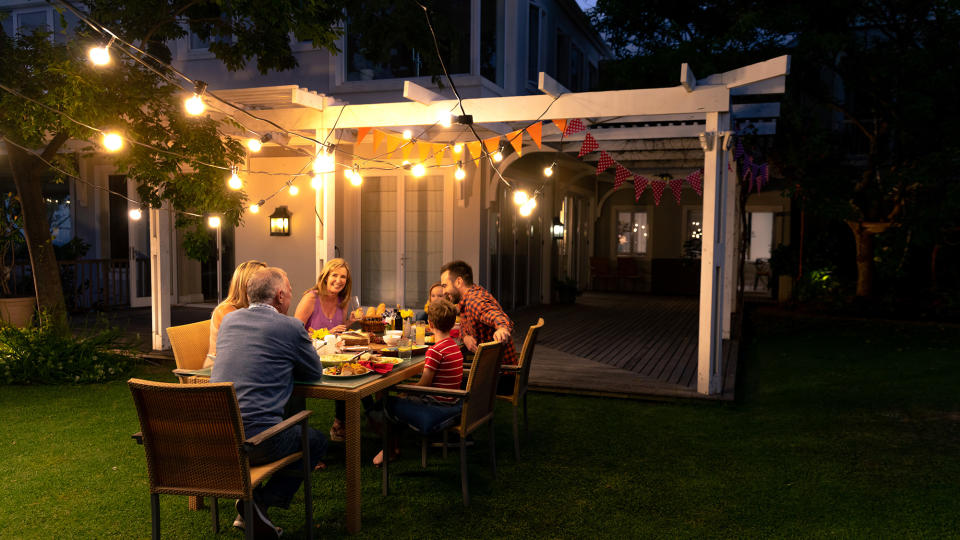 Family dining outside with ambient lighting