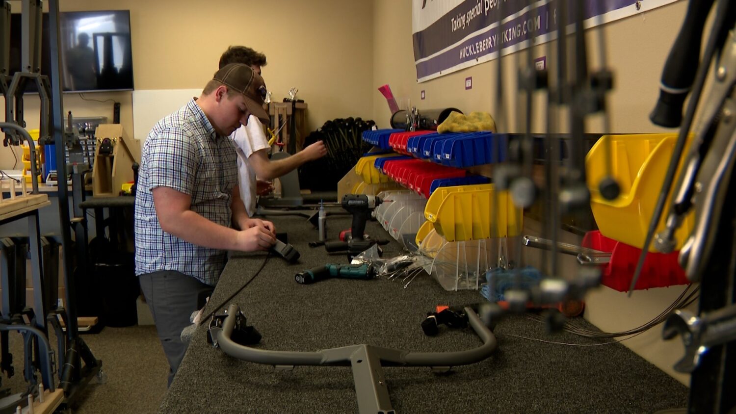 Workers at Huckleberry Hiking Building Cascade Carts in the workshop.