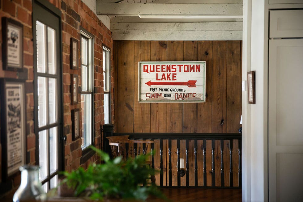 Queenstown Lake stair dealer signs A Queenstown Lake sign in a rustic wooden staircase
