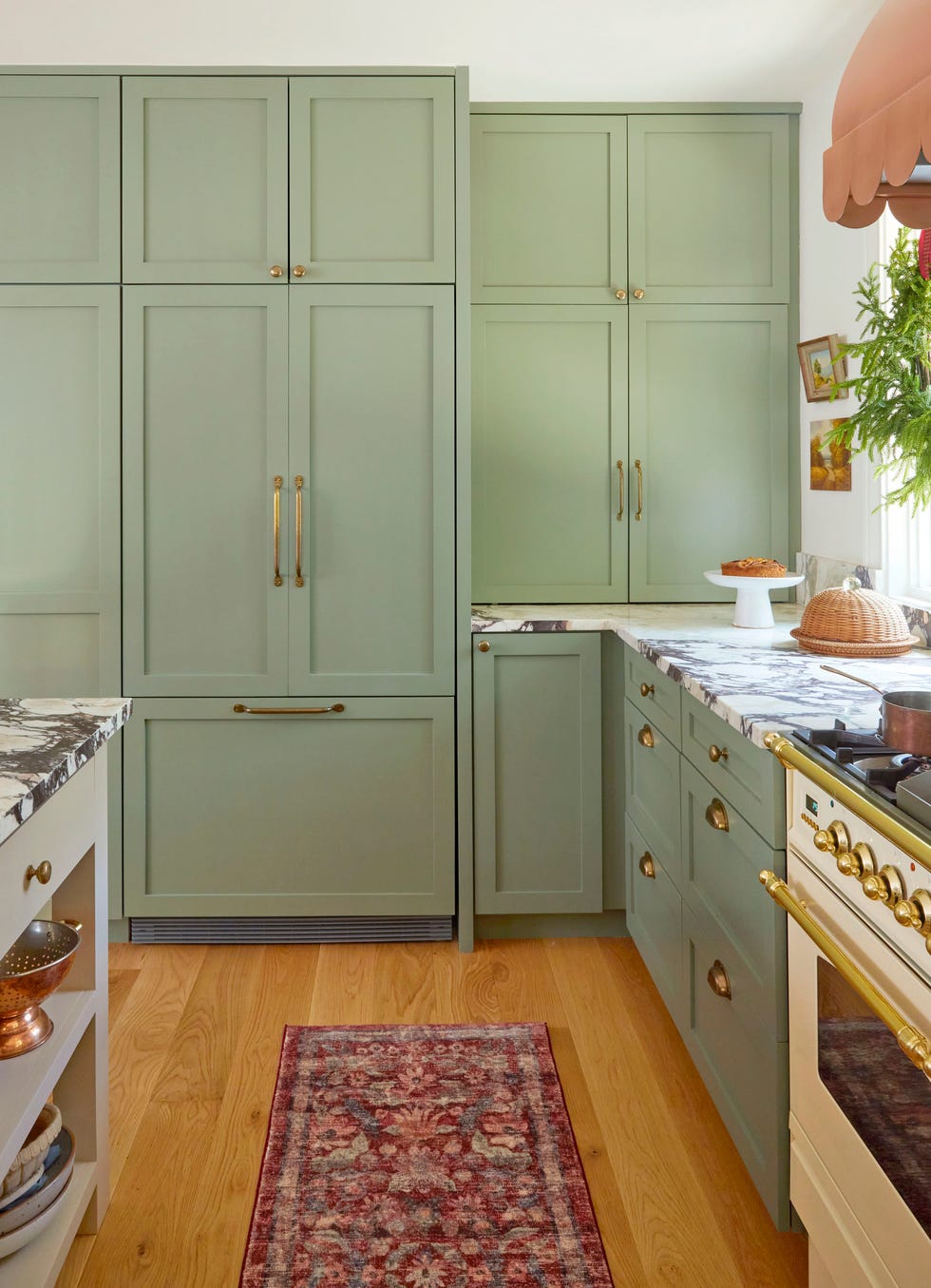 Modern kitchen with rustic flair with green cupboards and marble worktops