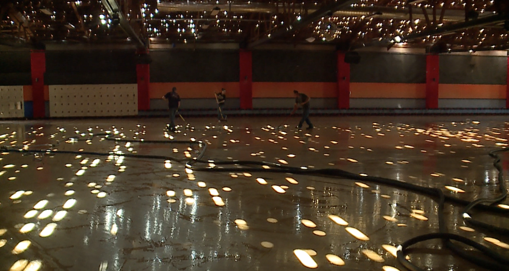 Occupations that work on cleaning the ice rink from rainwater