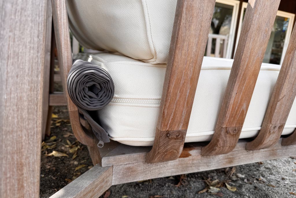 A close -up of the rolled -up rain cover, which is hidden outdoors behind the pillows of the outer tea clever.
