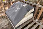 The outdoor tea clever outdoors, which is shown with his built -in tarpaulins with tarpaulins that are draped over his pillows.