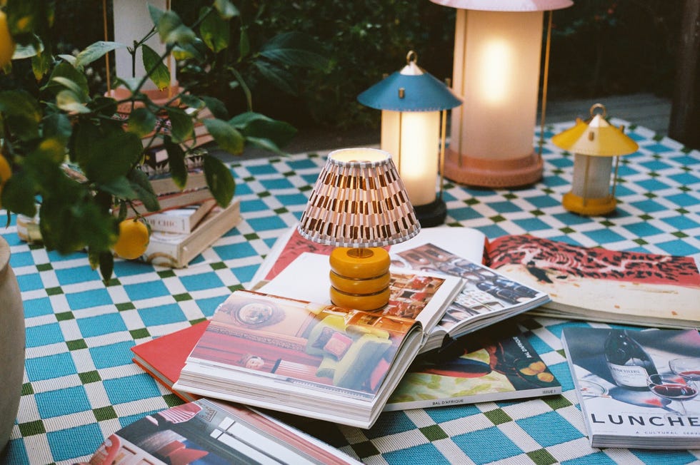A cozy outdoor environment with books and lamps.