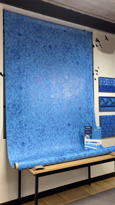 Large blue vinyl sheet with the Baia pattern of Pool by CGT, which is displayed with product signs and swatch panels.