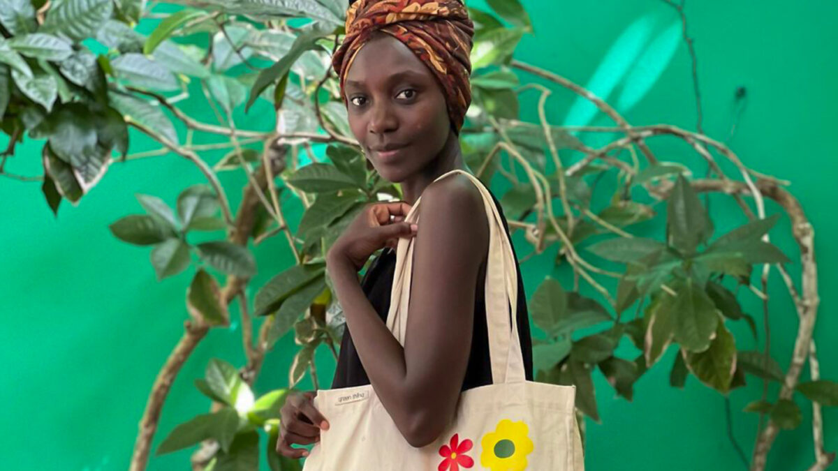 Nelly Gesare poses with an environmentally friendly shopping bag from Green Thing Kenya.