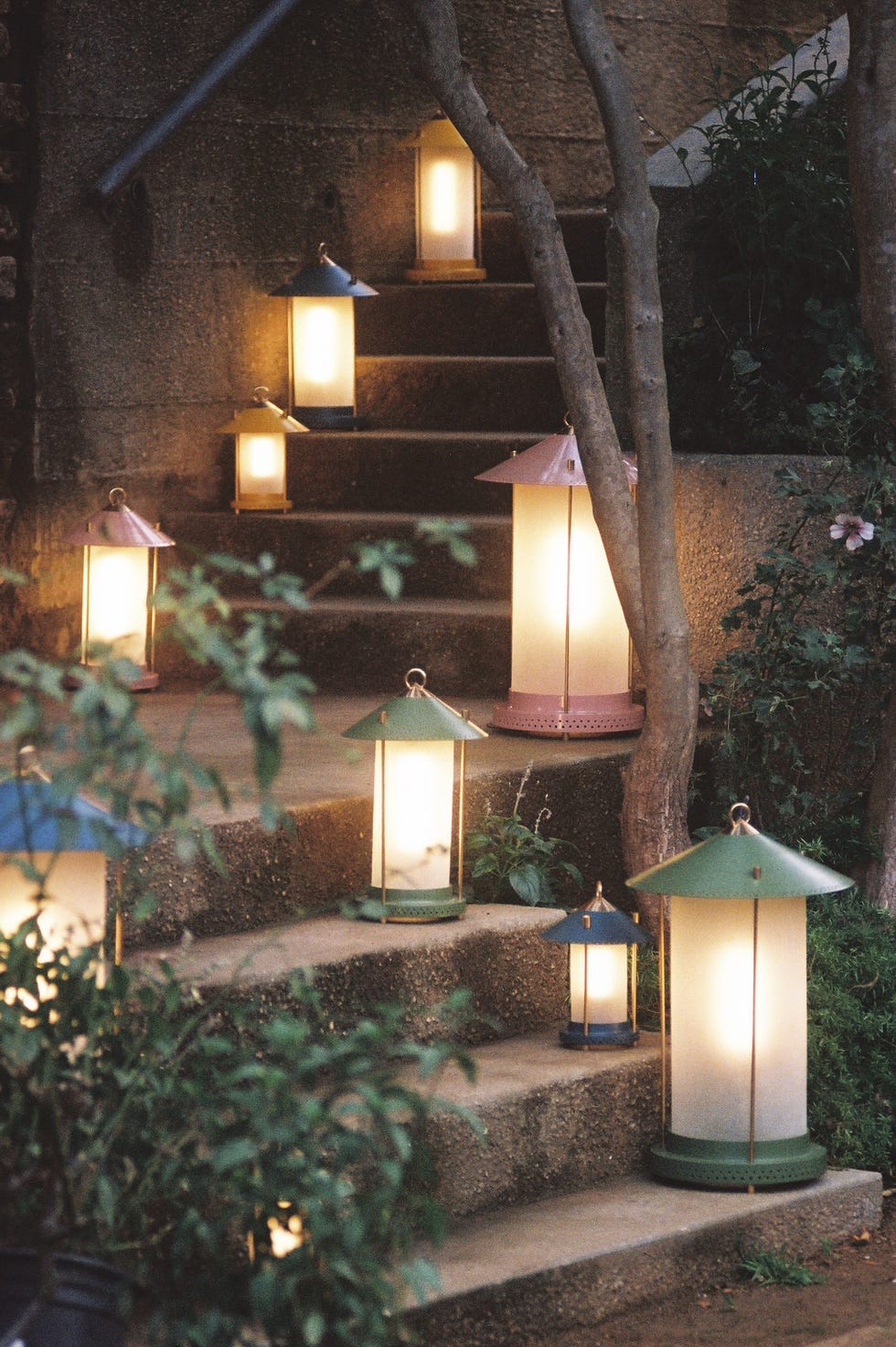 External stairs illuminated by various decorative lanterns.