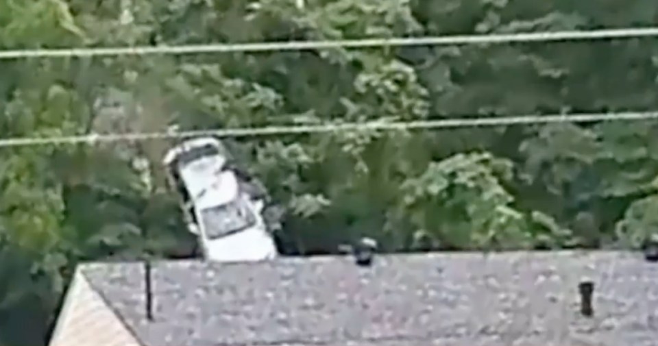 The car fell through a house roof.