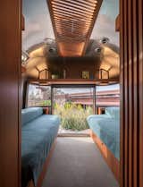 The trailer uses Wright's effect of compression and release, whereby a narrow hallway opens up to the ESTED in front and in the bedroom at the back.