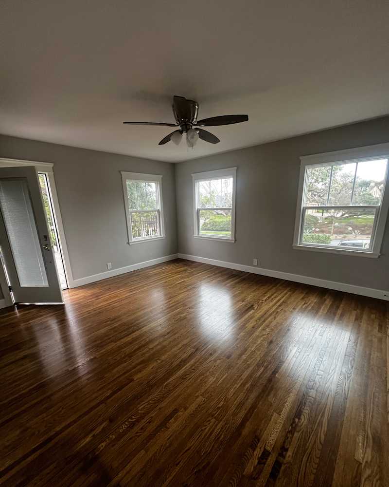 Empty room with wooden floors at home before staging.