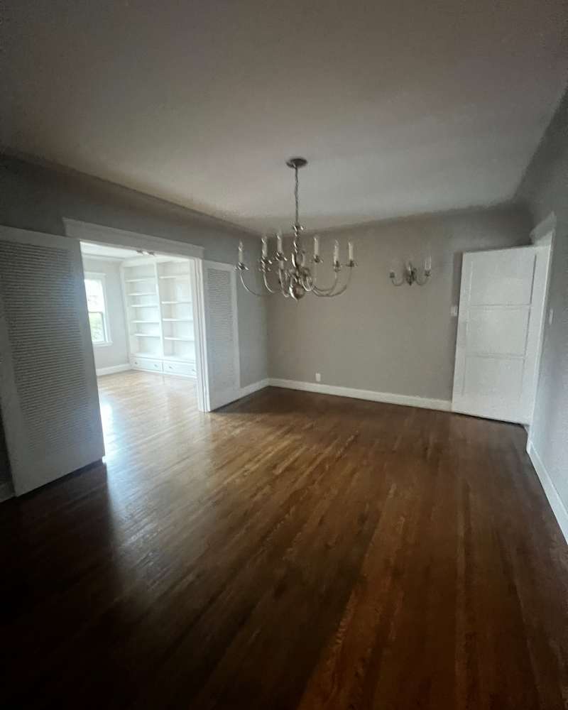 Hardwood floors in the empty room before the renovation.