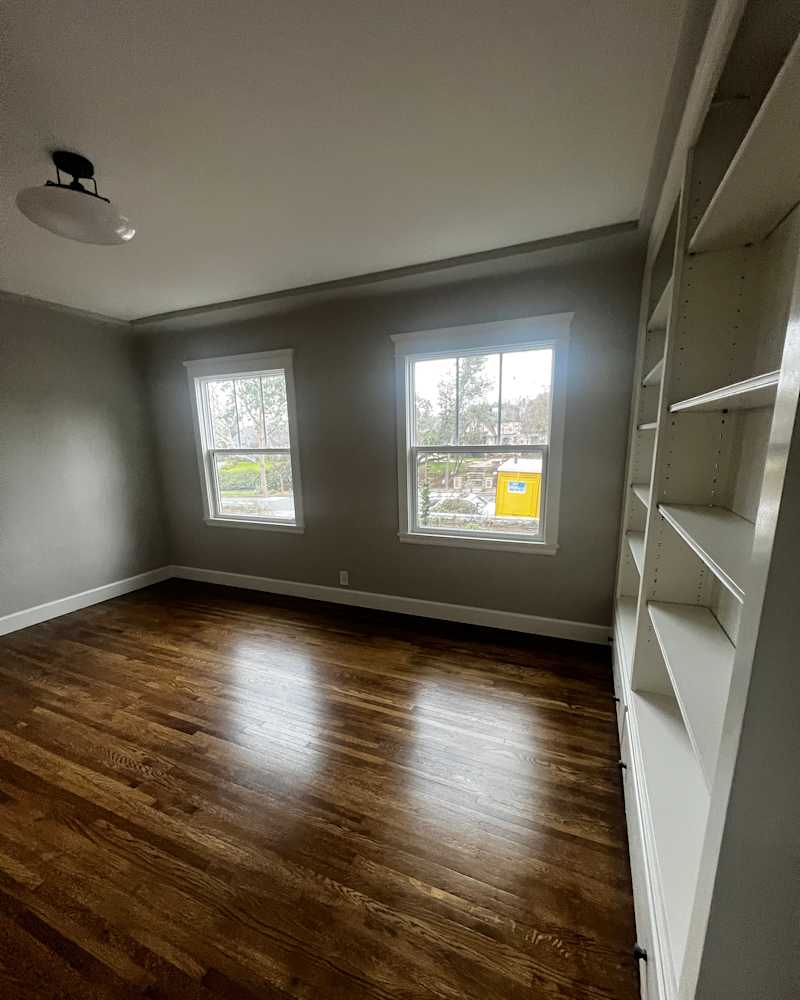 Windows in large space with built -in shelves before the staging at home.