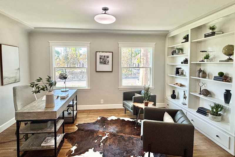 Cow blends in a newly renovated home office with decorated shelves built into the shelves.