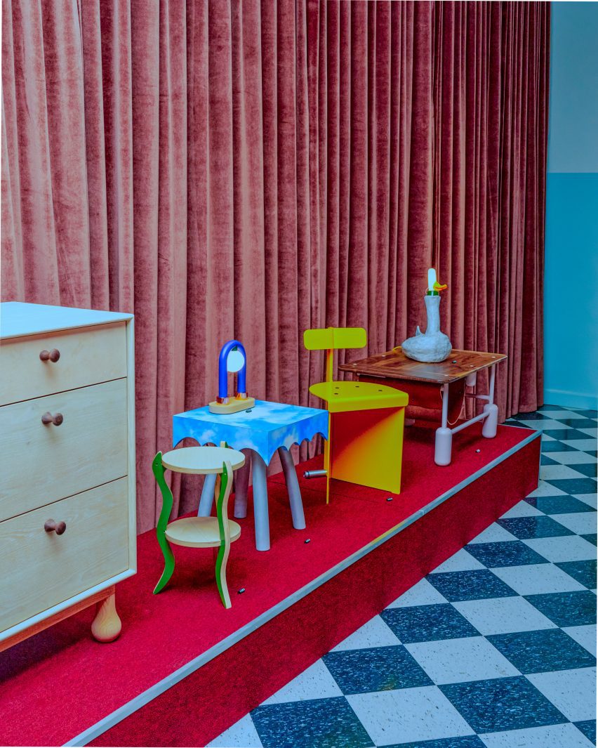 Avantgard designs that are presented on a red base against a velvet curtain