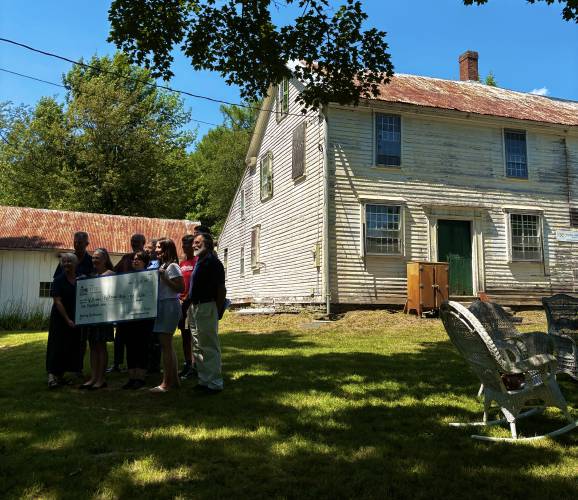 In the Williams-Boltwood House in Goshen on Wednesday, a representative of the Massachusett Preservation presented a check of $ 10,000 to board members of a group that collected donations for the restoration of the house.