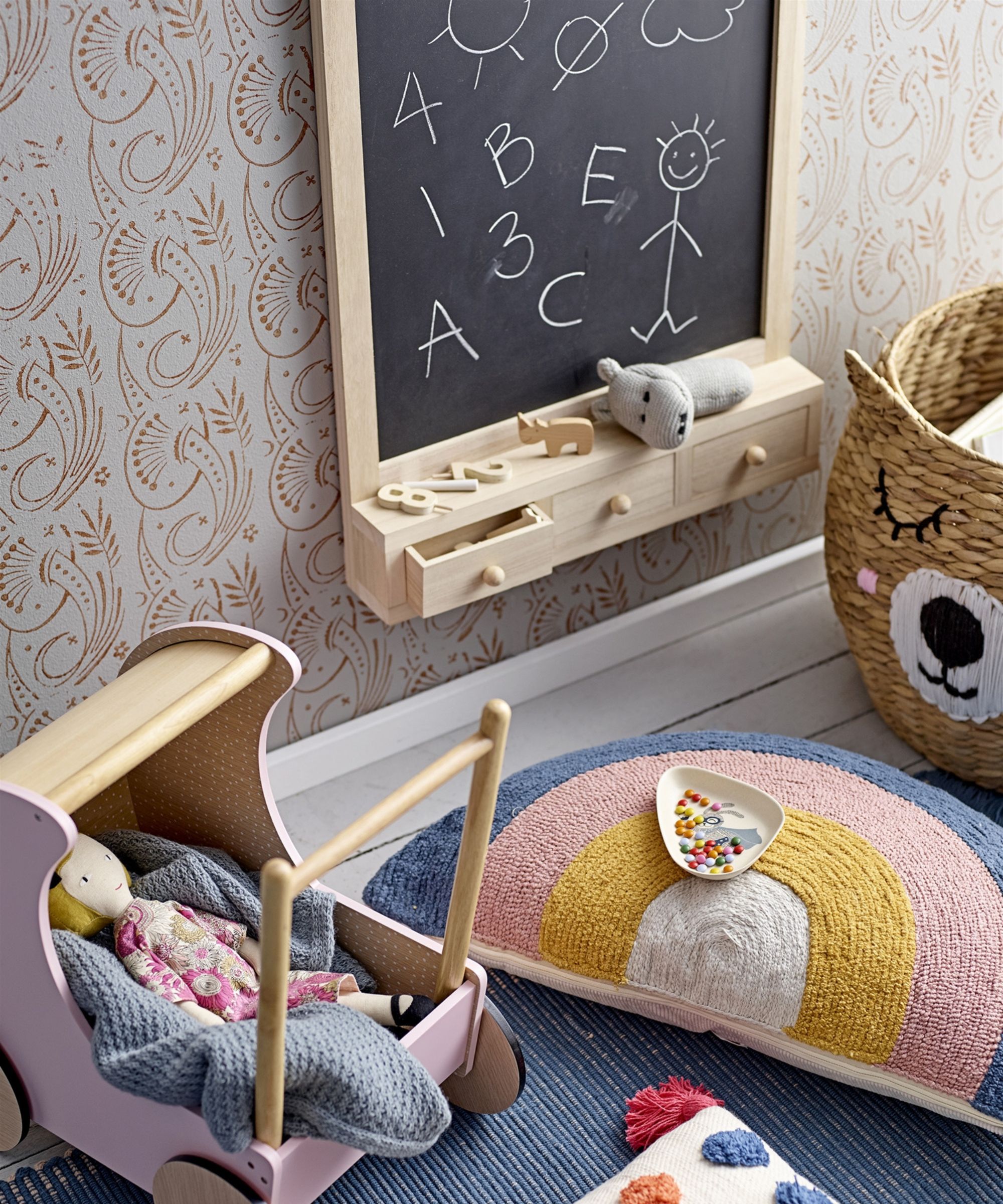 A small wall mounting table with drawers next to some colorful children's toys