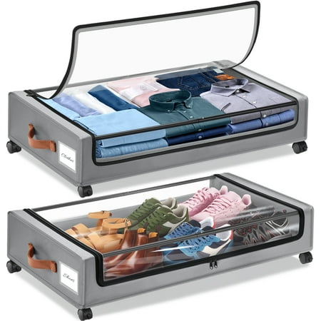 Two gray fabric storage bags for under the bed, on black plastic wheels with clear lids. Shoes in the lower pocket and folded shirts in the upper pocket. 