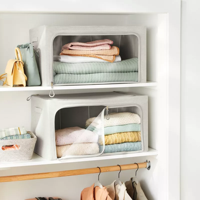 Two clear storage boxes on the cabinet shelves