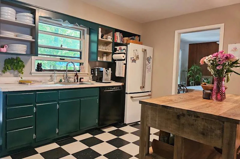 Cupboards painted green in slow conversion kitchen.