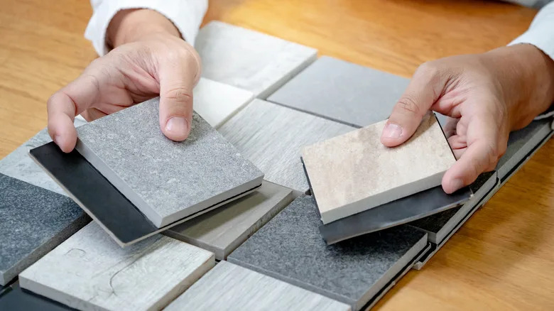 One person compares worktop material samples