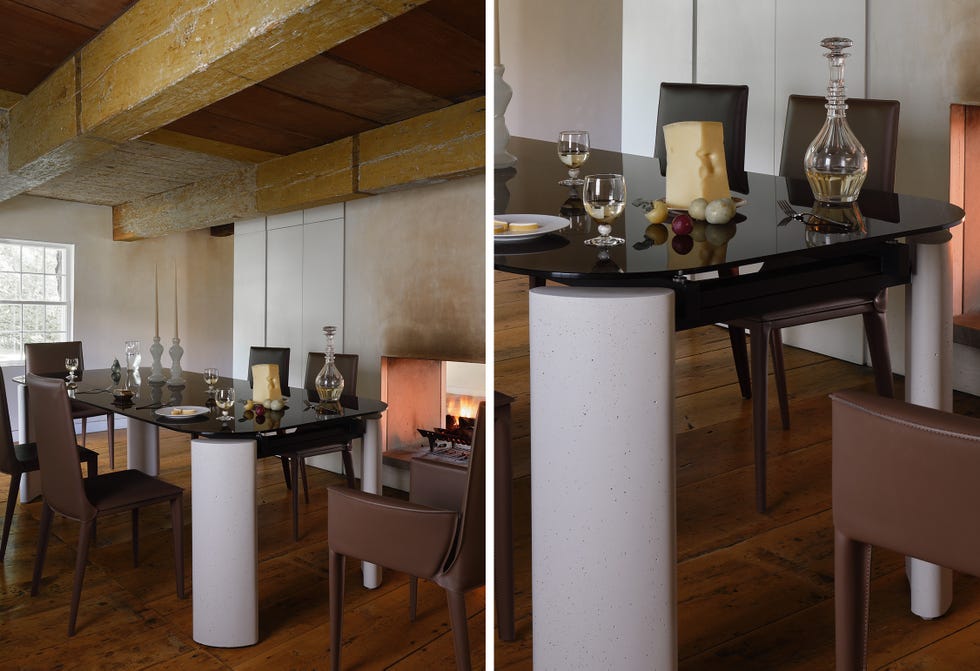 Modern dining room with glass table and elegant decor.