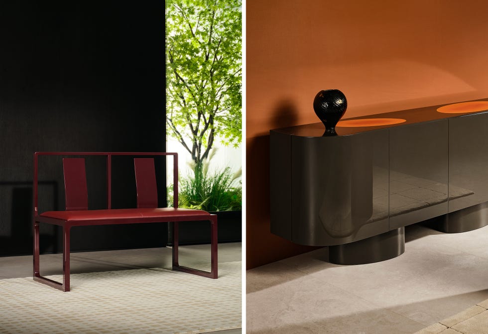 Contemporary furniture including a red bench and a dark cupboard.