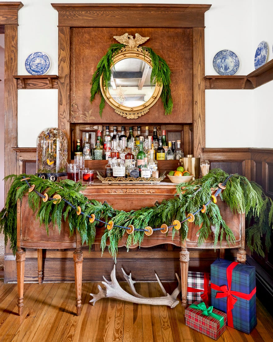 Farmer's Bar Christmas Wooden buffet set up as a Christmas bar with garland hanging around
