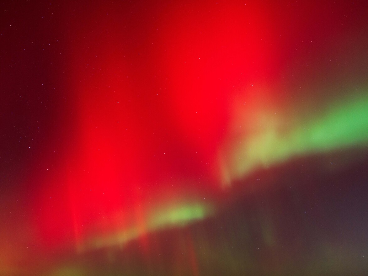 The Aurora Borealis shines over rural Monroe County, Wisconsin, as a powerful geomagnetic storm pushes the Northern Lights unusually far south on Wednesday due to recent solar activity.